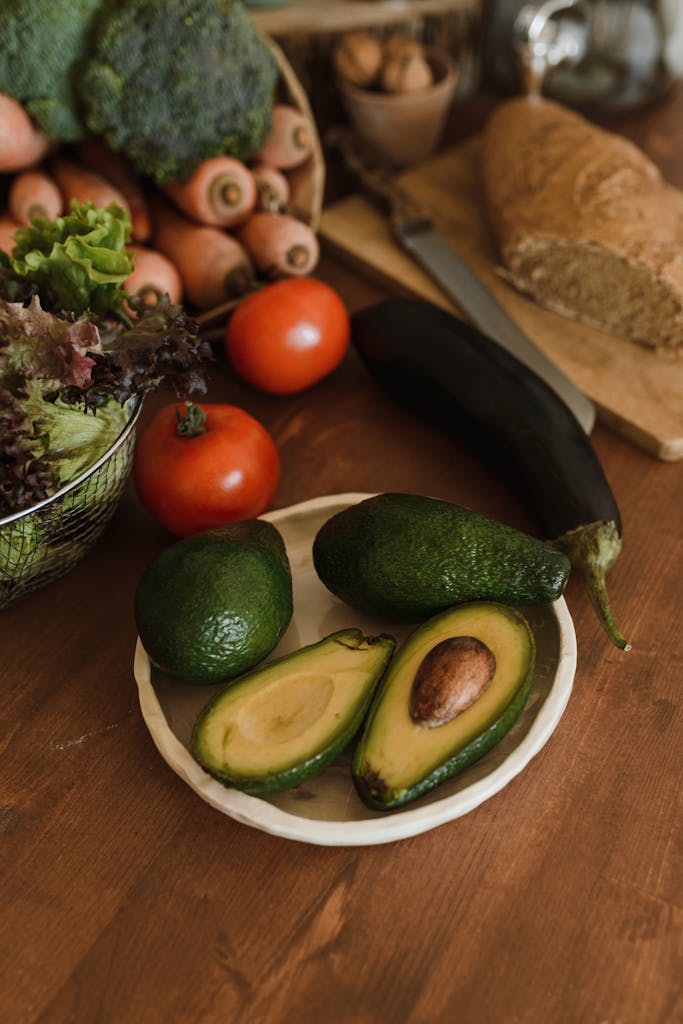 Top view of fresh organic vegetables and bread on a rustic wooden table for healthy meals.